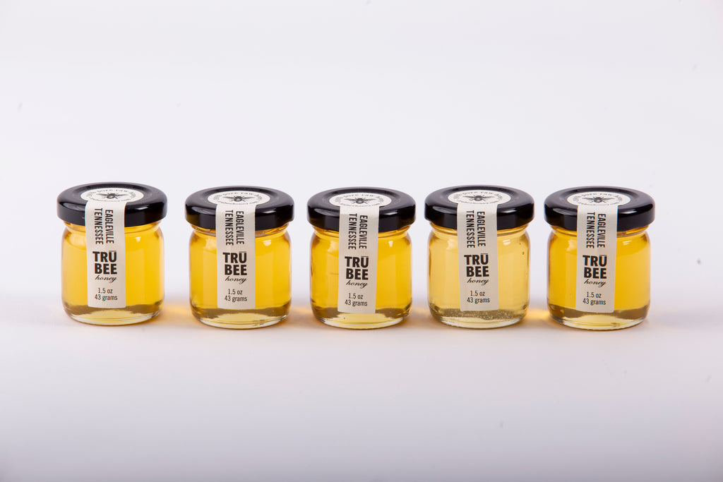 Five TruBee Honey mini jars in a row